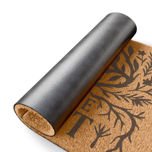 Rectangular coir doormat featuring black-ink artwork of a large all-seeing eye surrounded by branches, leaves, and forest flora. Beneath the design, the phrase “Eye of the Forest” is printed in bold serif font. Made from natural coconut coir with a vinyl backing, the mat measures 24 by 16 inches and is suitable for outdoor entryways.